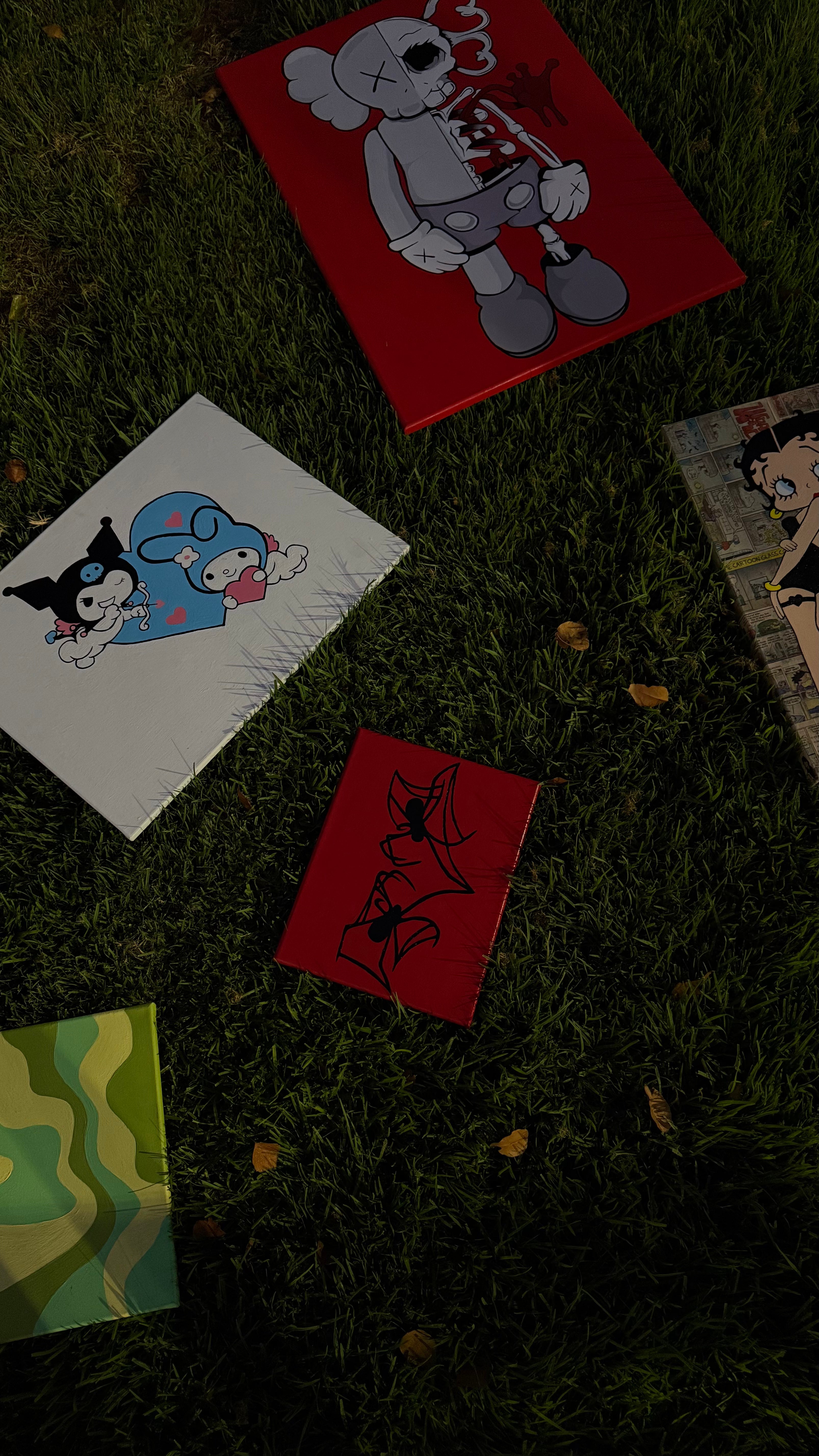 Cartoon-themed cards on a grassy surface